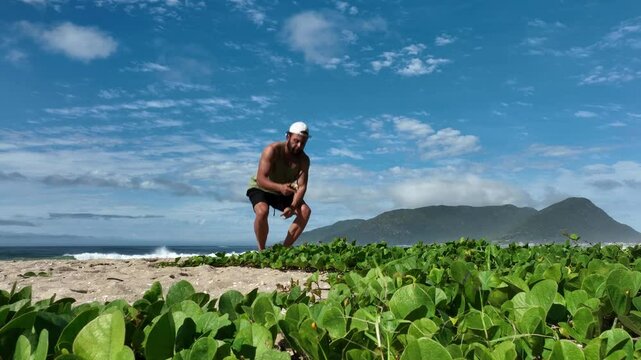 Man on a sunny day at the beach having a picnic, eating and drinking water. Outdoor concept.