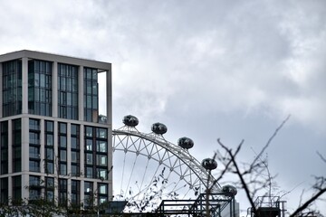View of London Eye behind a modern building 