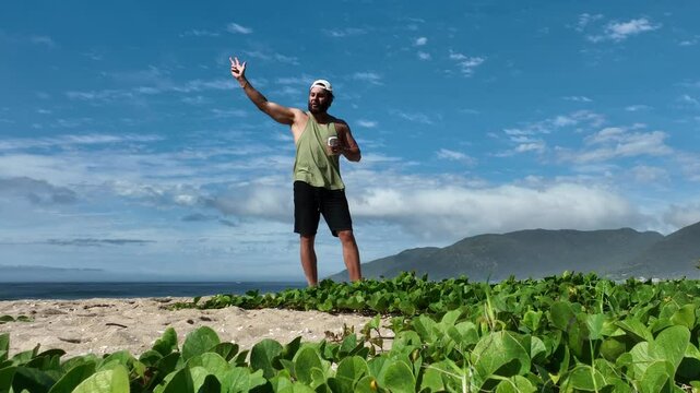 Man on a sunny day at the beach having a picnic, eating and drinking water. Outdoor concept.