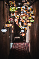 Background from traditional Arabic glass and metal lamps in shop in the Medina of Marrakesh, Morocco