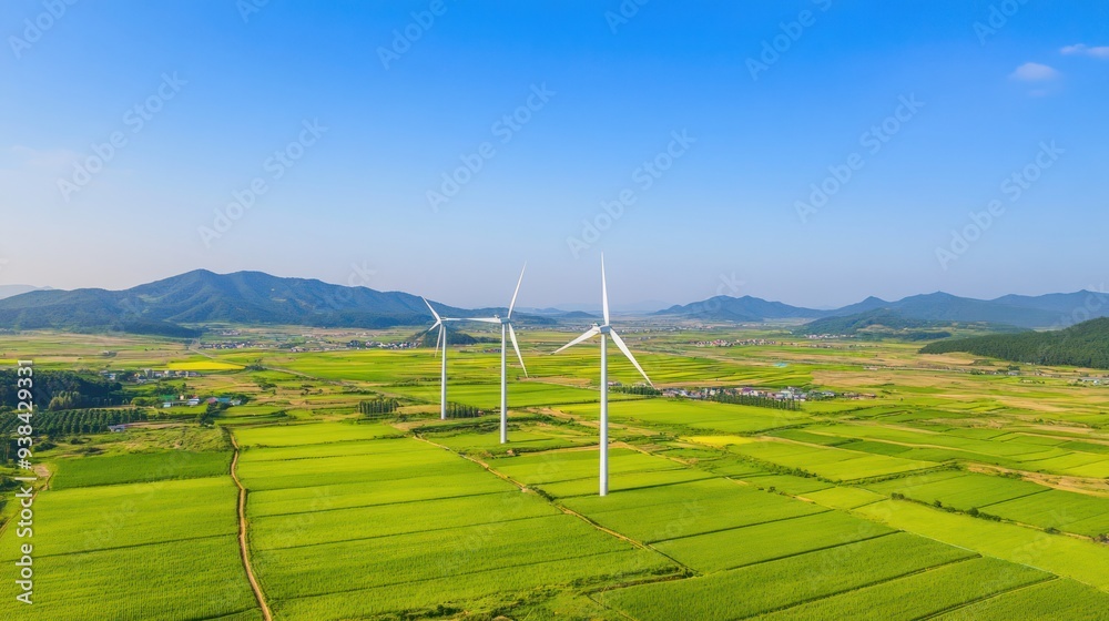 Wall mural wind turbines in a green landscape