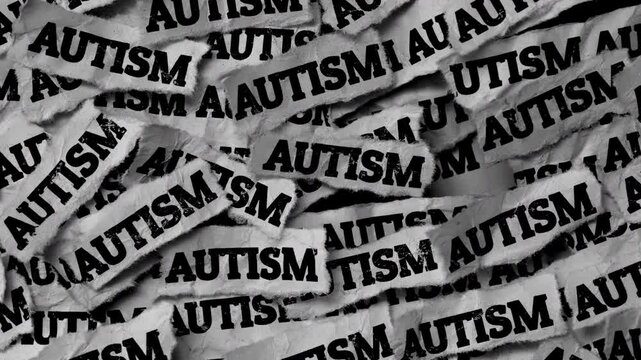 Strips of newspaper with the words Autism typed on them. Black and white. Close up.