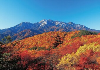 Stunning Autumn Landscape with Vibrant Foliage and Majestic Mountain Range Under Clear Blue Sky - A Perfect Fall Day in Nature's Paradise