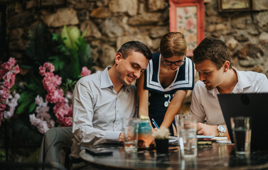 A group of colleagues collaborate in a cozy cafe, surrounded by vibrant flowers. They are working together, sharing ideas, and enjoying a creative atmosphere.