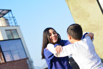 Happy latin kids playing outside.