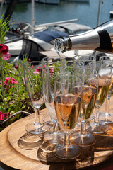 Summer party, French brut rose champagne sparkling wine in flute glasses in yacht harbour of Port Grimaud near Saint-Tropez, French Riviera vacation, Var, France