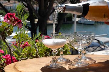 Summer party, French brut rose champagne sparkling wine in coupe glasses in yacht harbour of Port Grimaud near Saint-Tropez, French Riviera vacation, Var, France