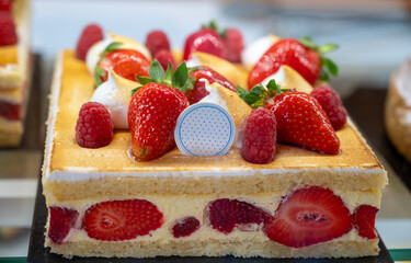 Red fruit sweet dessert cheesecake tart with fresh strawberries in bakery
