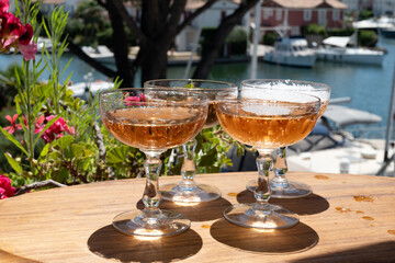 Summer party, French brut rose champagne sparkling wine in coupe glasses in yacht harbour of Port Grimaud near Saint-Tropez, French Riviera vacation, Var, France