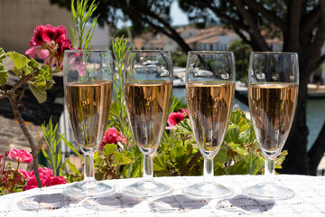 Summer party, French brut rose champagne sparkling wine in flute glasses in yacht harbour of Port Grimaud near Saint-Tropez, French Riviera vacation, Var, France