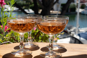 Summer party, French brut rose champagne sparkling wine in coupe glasses in yacht harbour of Port Grimaud near Saint-Tropez, French Riviera vacation, Var, France