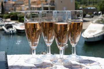Summer party, French brut rose champagne sparkling wine in flute glasses in yacht harbour of Port Grimaud near Saint-Tropez, French Riviera vacation, Var, France