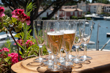 Summer party, French brut rose champagne sparkling wine in flute glasses in yacht harbour of Port Grimaud near Saint-Tropez, French Riviera vacation, Var, France