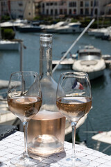 Glasses of cold rose gris Cote de Provence wine in yacht harbour of Port Grimaud, summer vacation on French Riviera in Provence, France