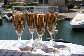 Summer party, French brut rose champagne sparkling wine in flute glasses in yacht harbour of Port Grimaud near Saint-Tropez, French Riviera vacation, Var, France