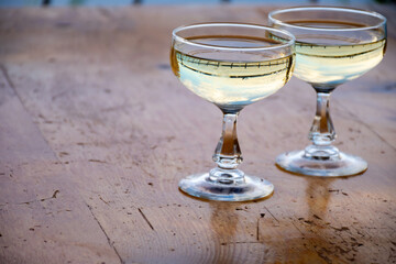 Sparkling wine, cava or champagne in two coupe glasses on wooden table, French Riviera is summer, France