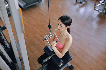 A Woman Pulling Down Weight In The Morning 