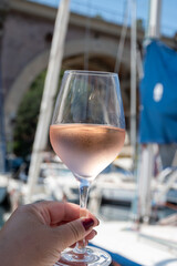 Party with rose wine on yacht boat anchored in port la Rague, Gulf of La Napoule, in Provence, two glasses of cold rose wine, French Riviera near Cannes, south of France