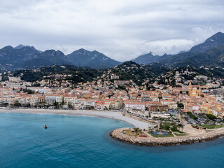 Fototapeta premium Aerial view on French Riviera, colorful Menton old city and marina on Mediterranean Sea near French-Italian border, travel destination, panoramic view from above