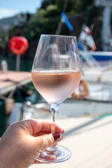 Party with rose wine on yacht boat anchored in port la Rague, Gulf of La Napoule, in Provence, two glasses of cold rose wine, French Riviera near Cannes, south of France