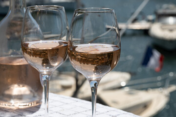 Glasses of cold rose gris Cote de Provence wine in yacht harbour of Port Grimaud, summer vacation on French Riviera in Provence, France