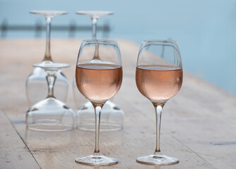 Summer time in Provence, two glasses of cold rose wine with blue sea view on background, French Riviera near Menton, south of France