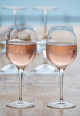 Summer time in Provence, two glasses of cold rose wine with blue sea view on background, French Riviera near Menton, south of France