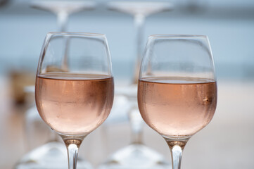 Summer time in Provence, two glasses of cold rose wine with blue sea view on background, French Riviera near Menton, south of France