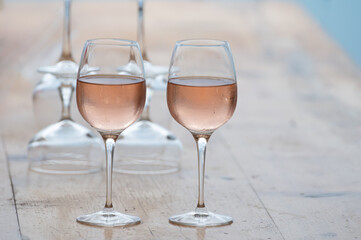 Summer time in Provence, two glasses of cold rose wine with blue sea view on background, French Riviera near Menton, south of France