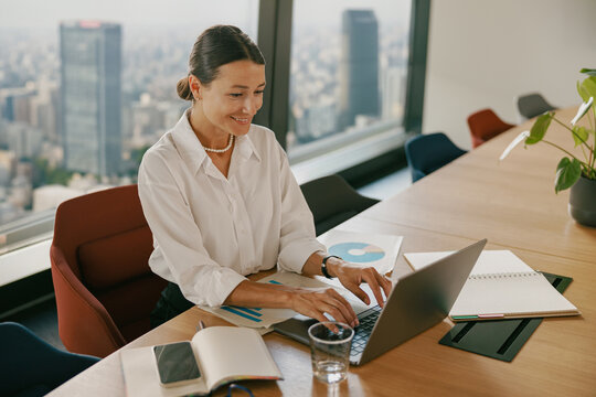 A Professional Woman Engaged in Work Within a Modern Office Setting and Environment
