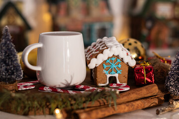 White mug and gingerbread house. Christmas decoration