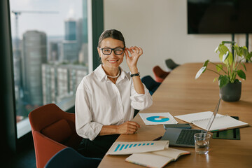 A Business Professional engaging in productive activities within a contemporary meeting space
