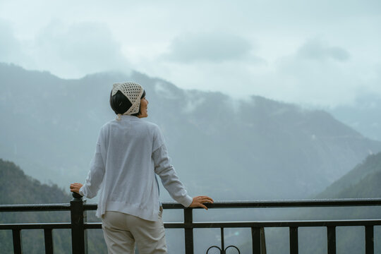 Summer girl portrait. Asian woman smiling happy on rainy summer or spring day outside in park.People with landscape concept.