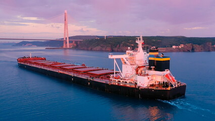 Bulk carrier designed to transport coal, metal ore, sand or timber. Merchant ship loaded with grains underway Bosporus. Elegant red ship gliding gently towards Istanbul, Turkey