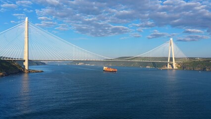 Container ship passing under the YSS cable bridge on Basphorus. Istanbul strait, a major transport hub for intercity and international cargo traffic. Yavuz Sultan Selim Bridge Europe and Asia