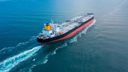 Oil tanker underway towards open sea. Crude oil tanker ship, a merchant ship specially designed for...