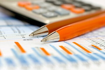 pen and calculator on financial newspaper