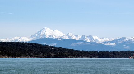 Panoramic view of Puget Sound and the snow-capped North Cascades with Mount Baker seen from a ferry.