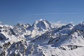 Snowcapped Alpine mountain peaks in the Three Valleys, France. Breathtaking view from popular Courchevel ski resort located in French Tarentaise Valley.
