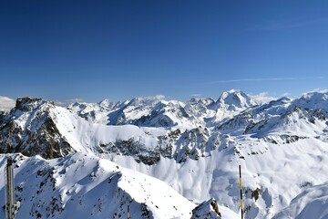 Snowcapped Alpine mountain peaks in the Three Valleys, France. Breathtaking view from popular Courchevel ski resort located in French Tarentaise Valley.