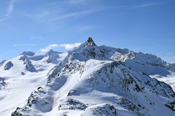 Snowcapped Alpine mountain peaks in the Three Valleys, France. Breathtaking view from popular Courchevel ski resort located in French Tarentaise Valley.