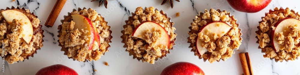 Sticker Delicious autumn-inspired muffins featuring apple pie crumble, topped with cinnamon spices and red apple slices.