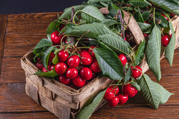 ripe cherries in a box on the table close up top view