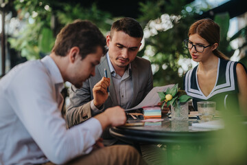 A group of business professionals engage in a discussion about sales strategies and marketing plans, focusing on report analysis and business growth in an outdoor environment.