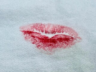 Fototapeta premium Red-orange lipstick kisses on tissue paper