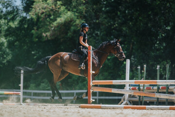 Equestrian rider and horse in action, jumping over obstacles in an outdoor horse jumping...