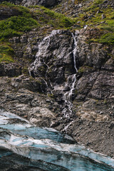 Waterfall and glacier in Glacier Bay National Park in Alaska in summer 