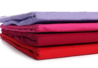 Stack of clean colorful t-shirts isolated on white