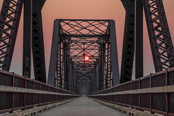 sunrise through the steel bridge