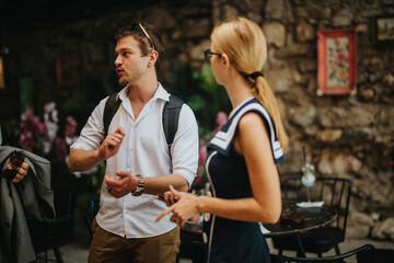 Two individuals engaging in a friendly discussion at an outdoor cafe. They appear relaxed and engaged in their conversation, surrounded by a cozy, rustic ambiance.